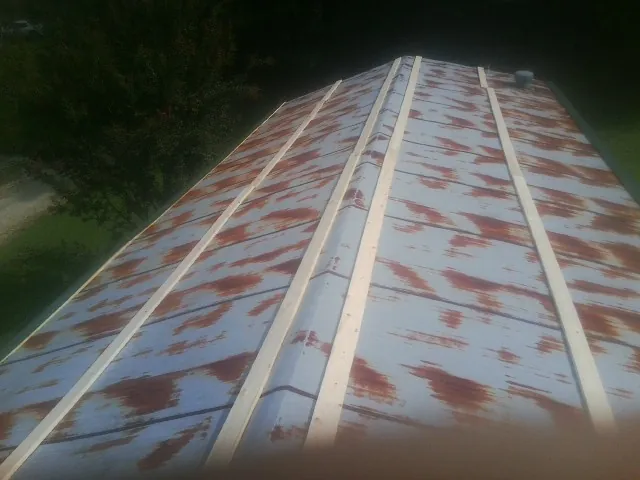 Rusted metal roof panels with new wood purlins before replacement — Storm Damage Roof Repair in Trufant by Roofing Brothers